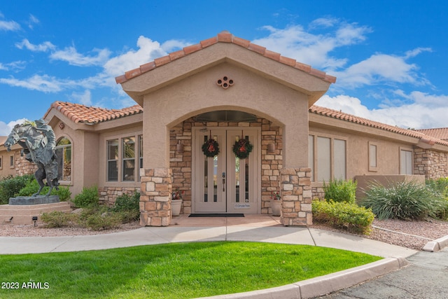 exterior space with french doors and a yard