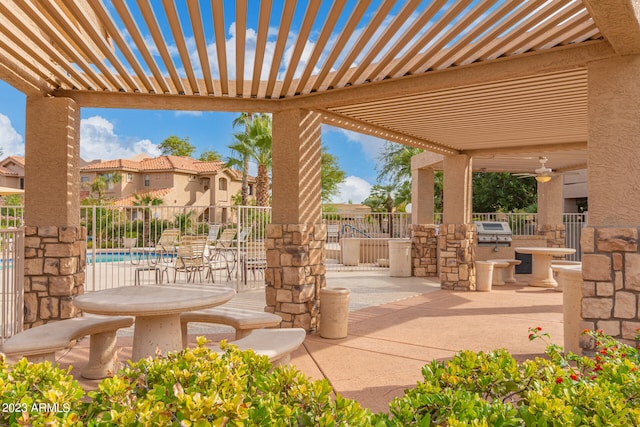 view of patio featuring grilling area, a pergola, and exterior kitchen