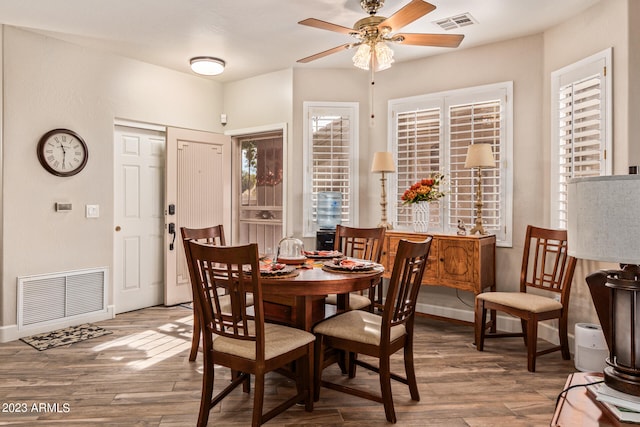 dining space featuring wood-type flooring and ceiling fan