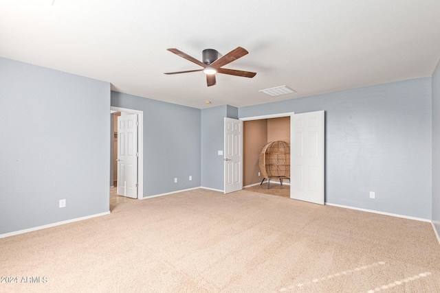 spare room with light carpet and ceiling fan