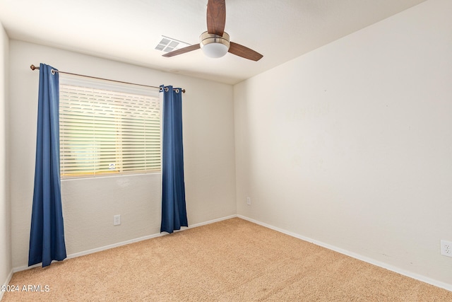 empty room with ceiling fan and light colored carpet