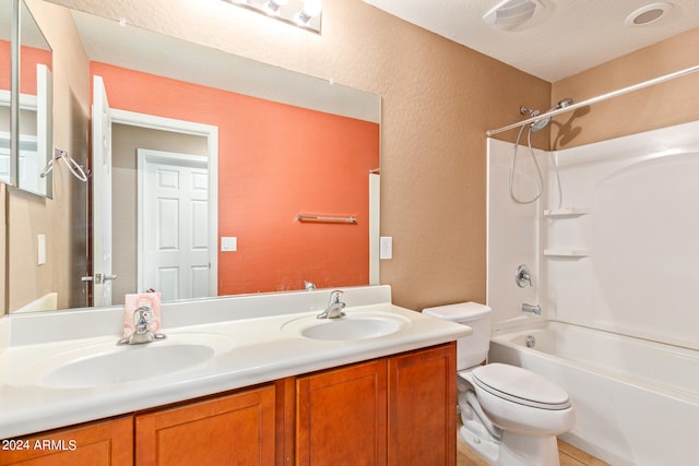 full bathroom with toilet, vanity, a textured ceiling, and tub / shower combination