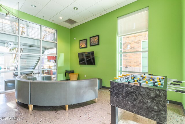 interior space featuring plenty of natural light and a drop ceiling