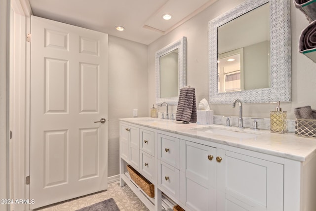 bathroom featuring tile patterned floors, a sink, recessed lighting, and double vanity