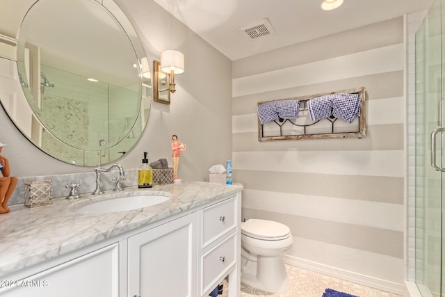 bathroom with visible vents, a shower stall, toilet, and vanity