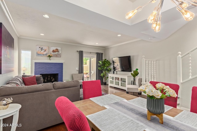 living room featuring recessed lighting, a fireplace, crown molding, and wood finished floors