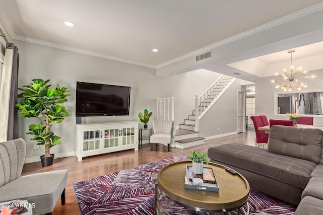 living room with a notable chandelier, wood finished floors, visible vents, stairs, and crown molding