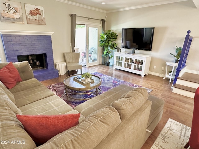 living room with a fireplace, baseboards, crown molding, and wood finished floors