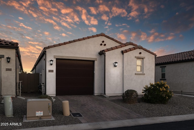 mediterranean / spanish house with a garage