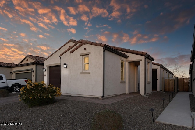 mediterranean / spanish home featuring a garage