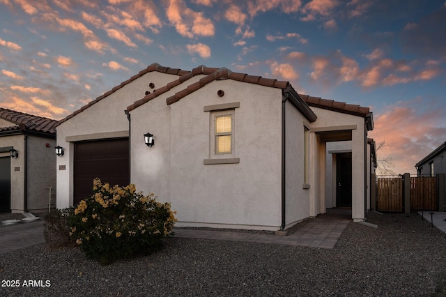 property exterior at dusk with a garage