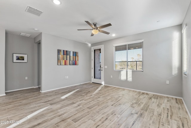 unfurnished room featuring ceiling fan and light wood-type flooring