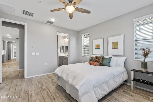 bedroom featuring light hardwood / wood-style floors, connected bathroom, and ceiling fan