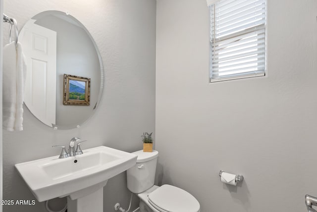 bathroom featuring sink and toilet