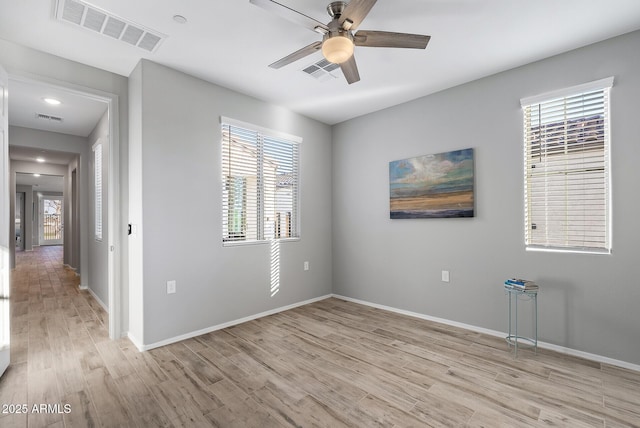 spare room with ceiling fan and light hardwood / wood-style flooring