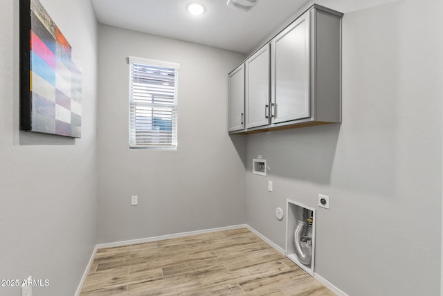 laundry area featuring hookup for an electric dryer, light wood-type flooring, cabinets, gas dryer hookup, and washer hookup