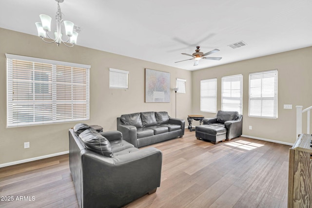 2118 N 77th Ln, Phoenix, AZ 85035 - living room with a chandelier, a ceiling fan, baseboards, and wood finished floors