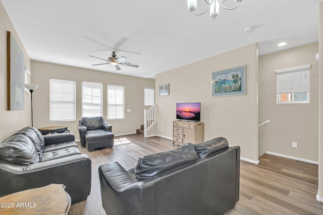 2118 N 77th Ln, Phoenix, AZ 85035 - living room with light wood finished floors, ceiling fan, baseboards, a chandelier, and recessed lighting