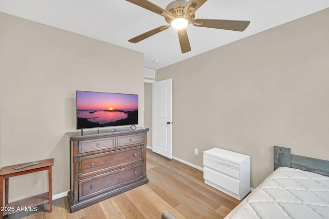 2118 N 77th Ln, Phoenix, AZ 85035 - bedroom with light wood finished floors, baseboards, and ceiling fan