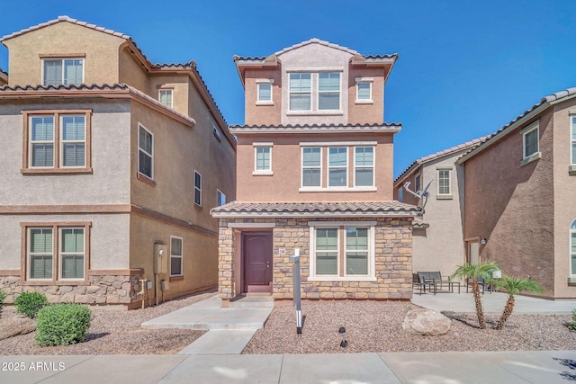 2118 N 77th Ln, Phoenix, AZ 85035 - view of front of property with stone siding, a tile roof, and stucco siding