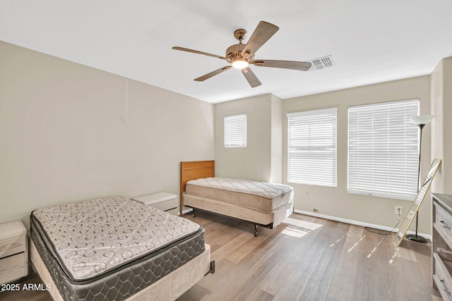 2118 N 77th Ln, Phoenix, AZ 85035 - bedroom featuring wood finished floors, ceiling fan, and baseboards