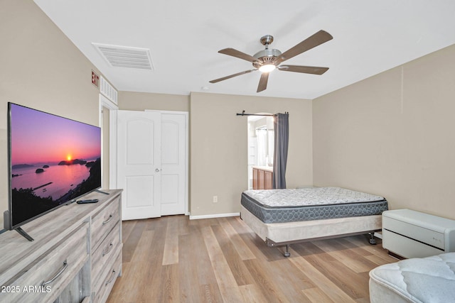 2118 N 77th Ln, Phoenix, AZ 85035 - bedroom featuring light wood finished floors, a ceiling fan, and baseboards