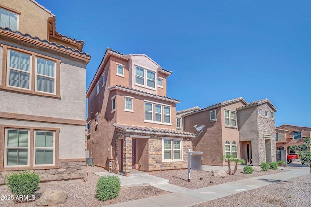 2118 N 77th Ln, Phoenix, AZ 85035 - view of front of property with stone siding, a tile roof, and stucco siding