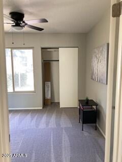 unfurnished bedroom featuring ceiling fan and carpet floors