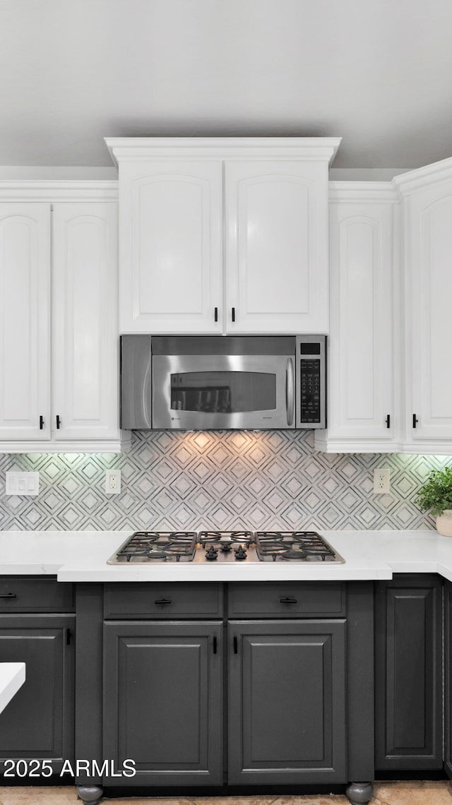 kitchen with gray cabinetry, appliances with stainless steel finishes, and white cabinets