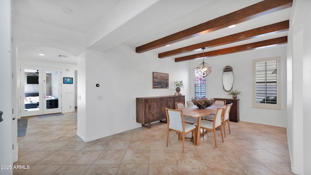 dining space featuring light tile patterned floors, baseboards, arched walkways, and beamed ceiling