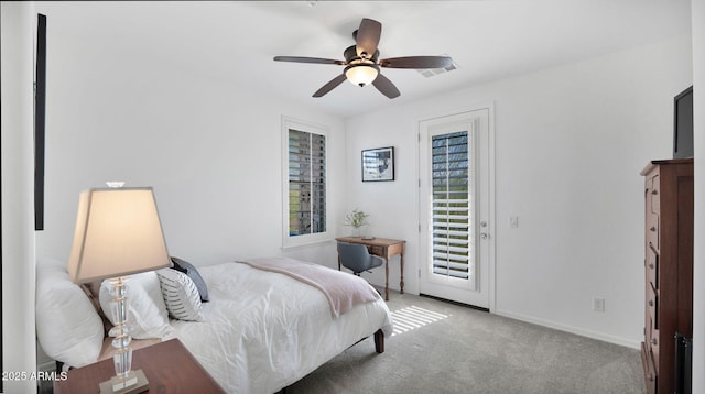 carpeted bedroom featuring access to exterior, baseboards, and a ceiling fan