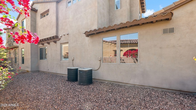 view of home's exterior with central AC unit and stucco siding