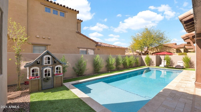 view of swimming pool with a fenced in pool, a fenced backyard, and a patio