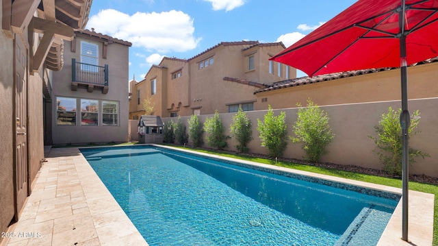 view of swimming pool with a fenced in pool, a residential view, a fenced backyard, and a patio