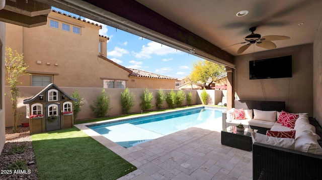 view of swimming pool with a patio, a fenced backyard, outdoor lounge area, a ceiling fan, and a fenced in pool