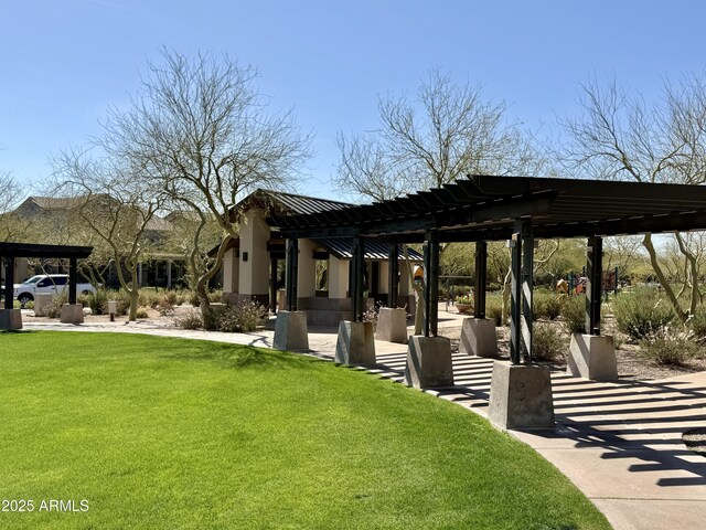 view of community with a patio area, a lawn, and a pergola