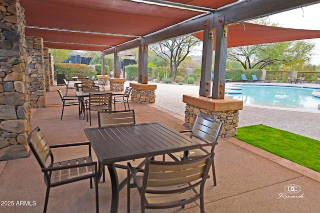 view of patio / terrace featuring fence, a fenced in pool, and outdoor dining space