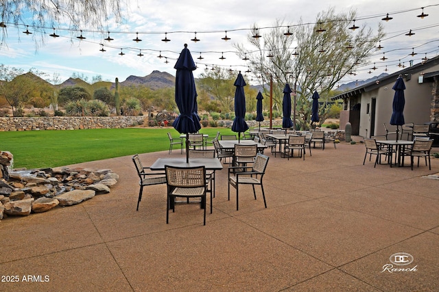 view of patio with a mountain view and outdoor dining area