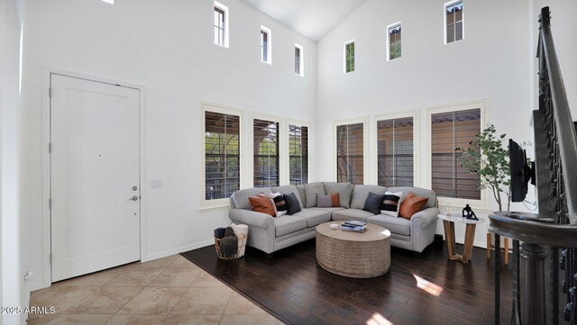 living room featuring a wealth of natural light, baseboards, and wood finished floors