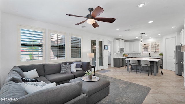 living room featuring light tile patterned floors, ceiling fan, visible vents, and recessed lighting