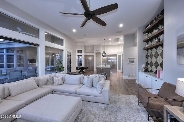 living room featuring ceiling fan and wood-type flooring