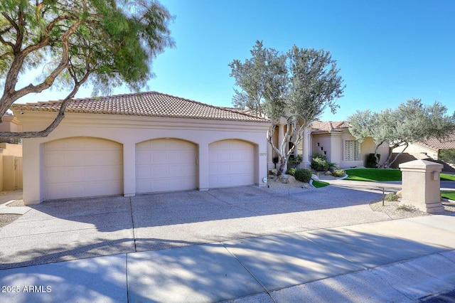 mediterranean / spanish-style house with a garage