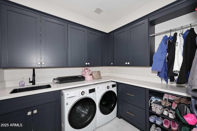 laundry room with cabinets, sink, and independent washer and dryer