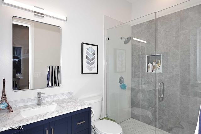 bathroom featuring vanity, toilet, and an enclosed shower