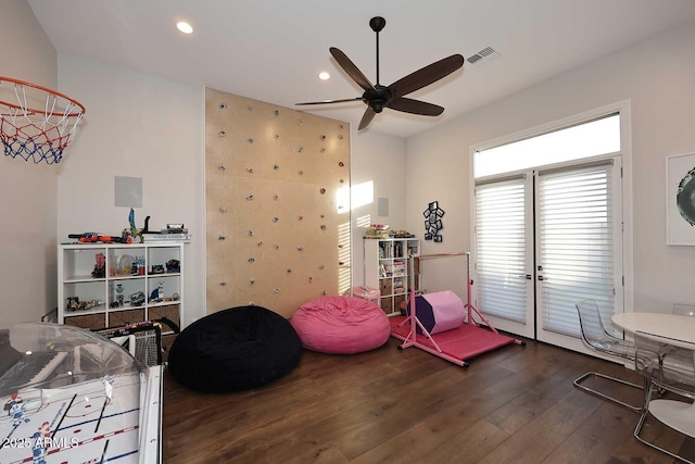 recreation room featuring ceiling fan and dark hardwood / wood-style floors