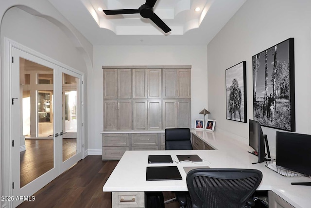 home office featuring built in desk, ceiling fan, a raised ceiling, and french doors