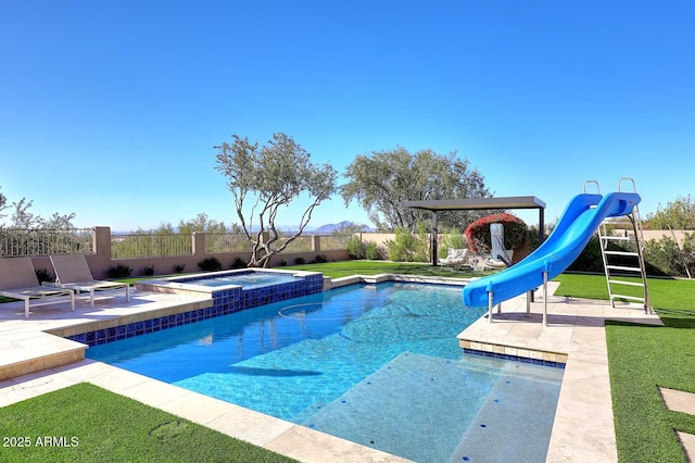 view of pool featuring an in ground hot tub, a patio area, a yard, and a water slide