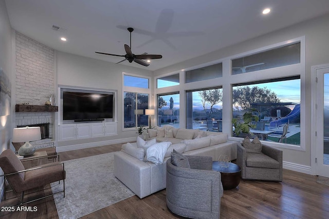 living room with wood-type flooring and ceiling fan