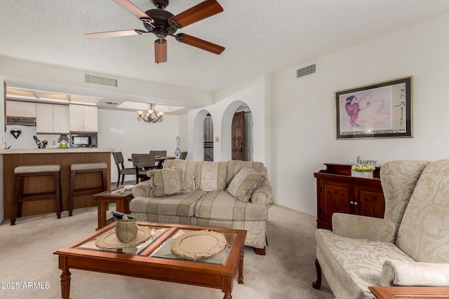 10410 N Cave Creek Rd Unit 2030, Phoenix, AZ 85020 - living area with light colored carpet, a ceiling fan, a textured ceiling, and a chandelier