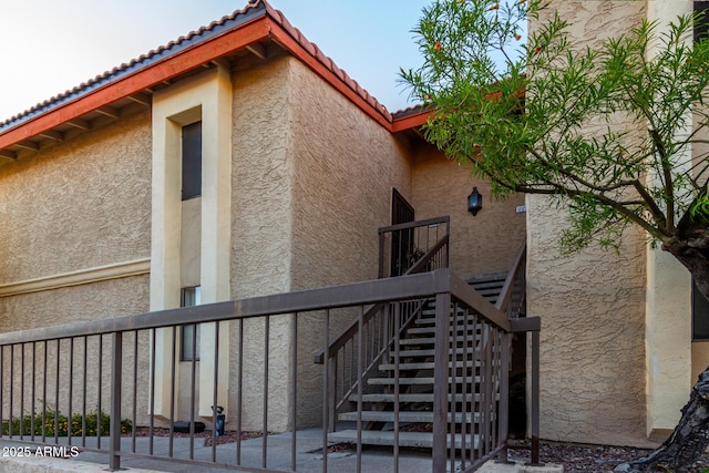 10410 N Cave Creek Rd Unit 2030, Phoenix, AZ 85020 - view of home's exterior with stucco siding, a tiled roof, and stairs